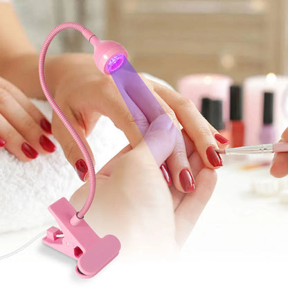 Pink nail LED Nail Lamp  being used on a person's hand with red nail polish.