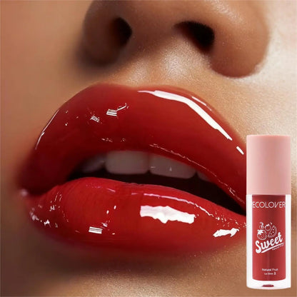 Close-up of glossy red Fruity Lip Gloss with a lip balm tube labeled 'Sweet' on a beige background