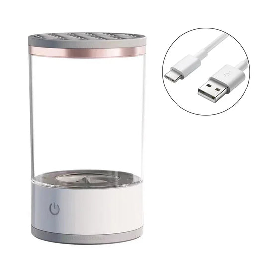 Clear cylindrical Makeup Brush Cleaner humidifier with power button and USB cable on a white background