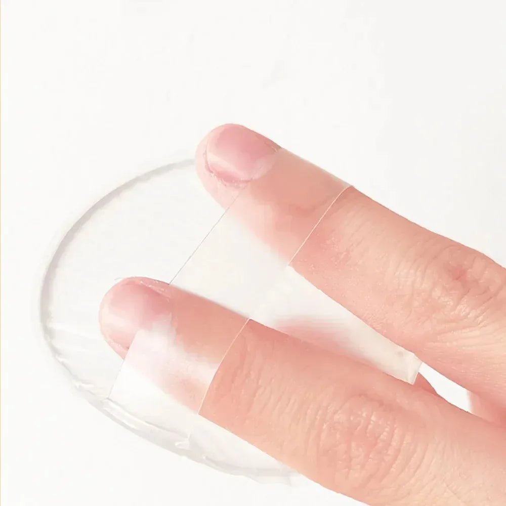Silicone Powder Puff pad on a finger against a white background