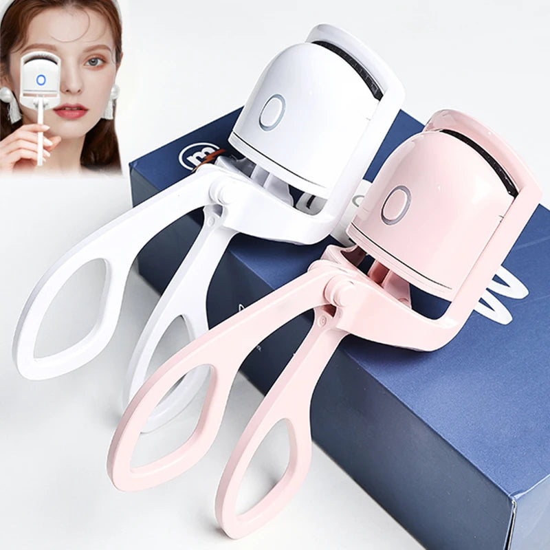 Two facial Electric Eyelash Curler  devices, one white and one pink, on a light gray background.