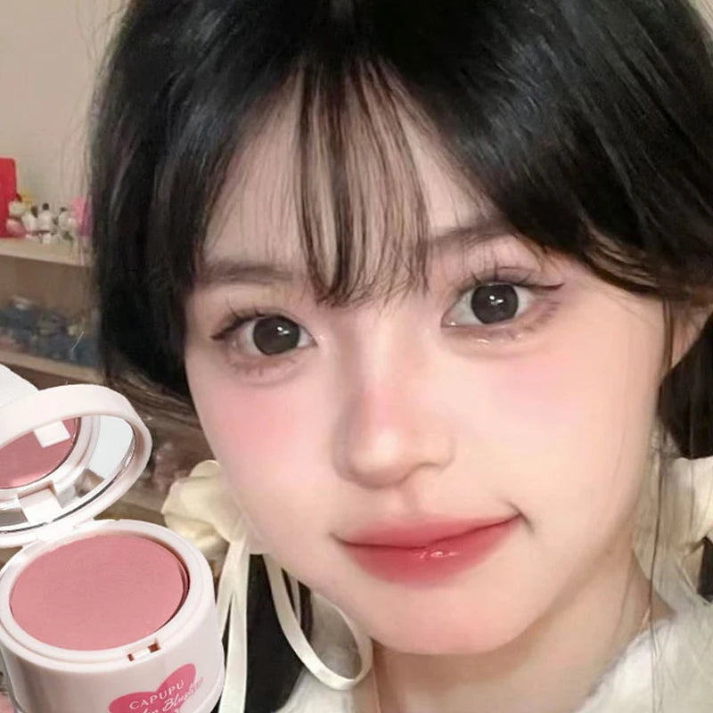 Close-up of a person with makeup products in the foreground - Powder Blush Palette