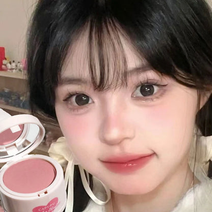 Close-up of a person with makeup products in the foreground - Powder Blush Palette