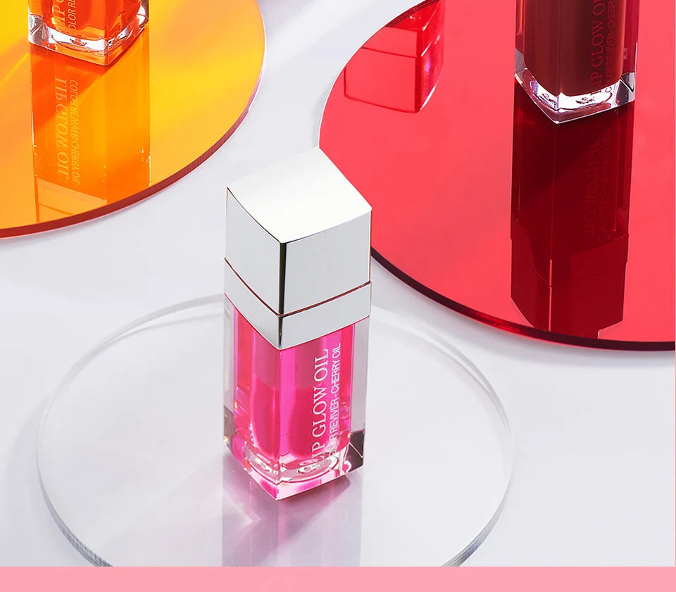 Moisturising Lip Balm Oil  skincare product with silver cap on a reflective surface