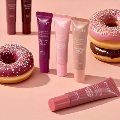 Qibest lip serum tubes on a pink background with donuts. Coloured Lip Gloss 