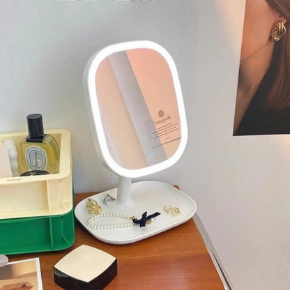 LED Vanity Mirror – Rotating Dimmable 3-Colour Lightmakeup mirror on a desk with jewelry and perfume